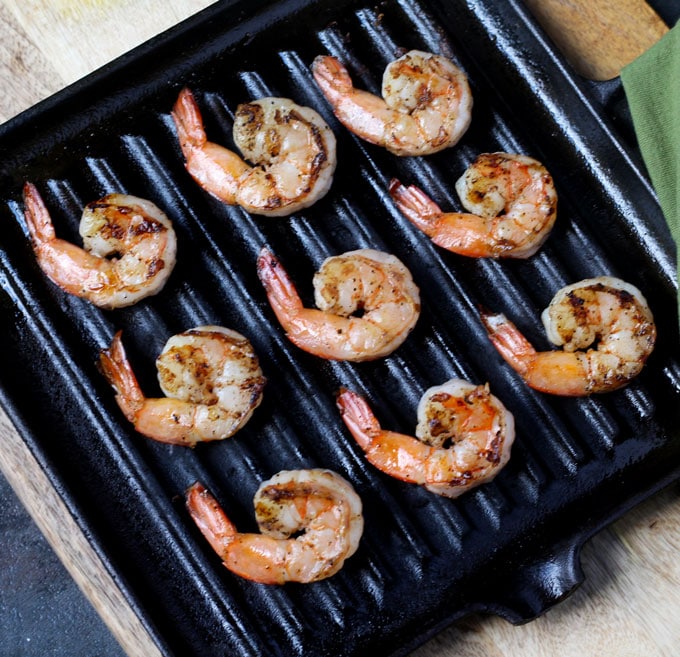 top view of 9 grilled shrimp on an electric grill