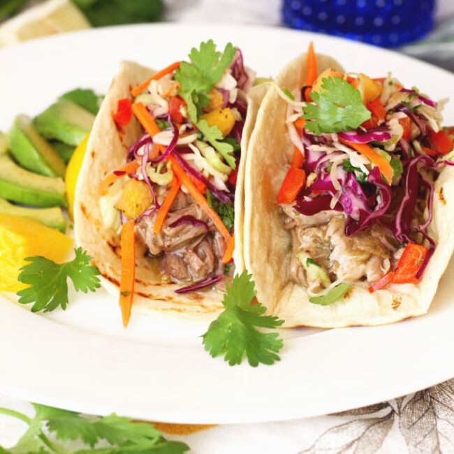 Tender and full of flavor Pulled Pork Chile Verde Style is wrapped in a tortilla and top with a fresh and crisp slaw that has just a hint of sweetness from fresh pineapple!