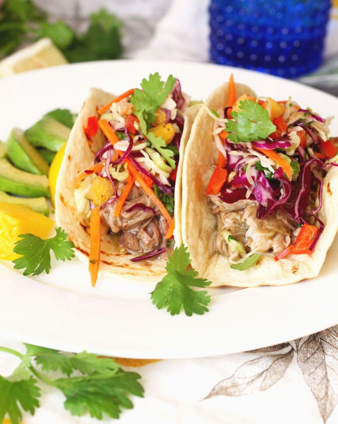 Tender and full of flavor Pulled Pork Chile Verde Style is wrapped in a tortilla and top with a fresh and crisp slaw that has just a hint of sweetness from fresh pineapple!