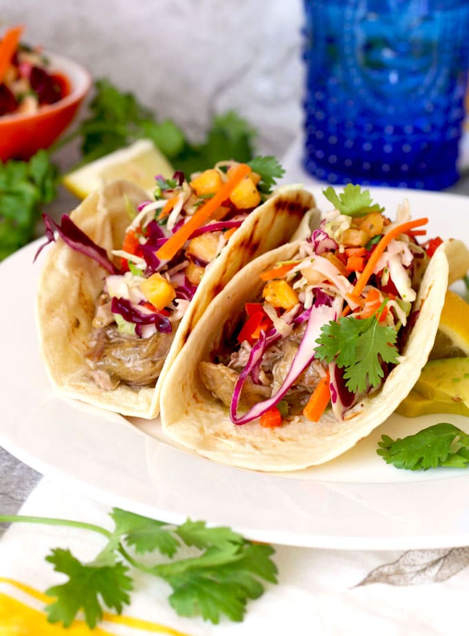 Tender and full of flavor Pulled Pork Chile Verde Style is wrapped in a tortilla and top with a fresh and crisp slaw that has just a hint of sweetness from fresh pineapple!