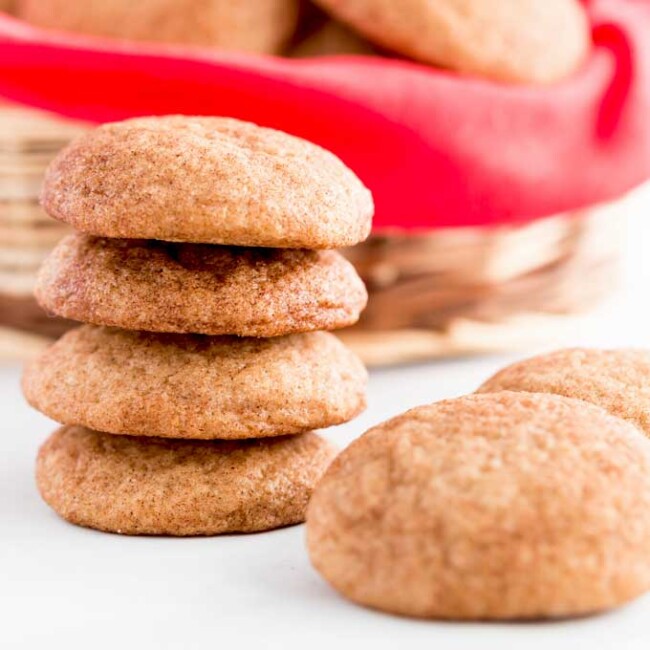 Stack of snickerdoodle cookies on a white surface