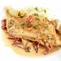 Creamy Chicken pan seared and served with a creamy artichoke and sun dried tomato sauce.