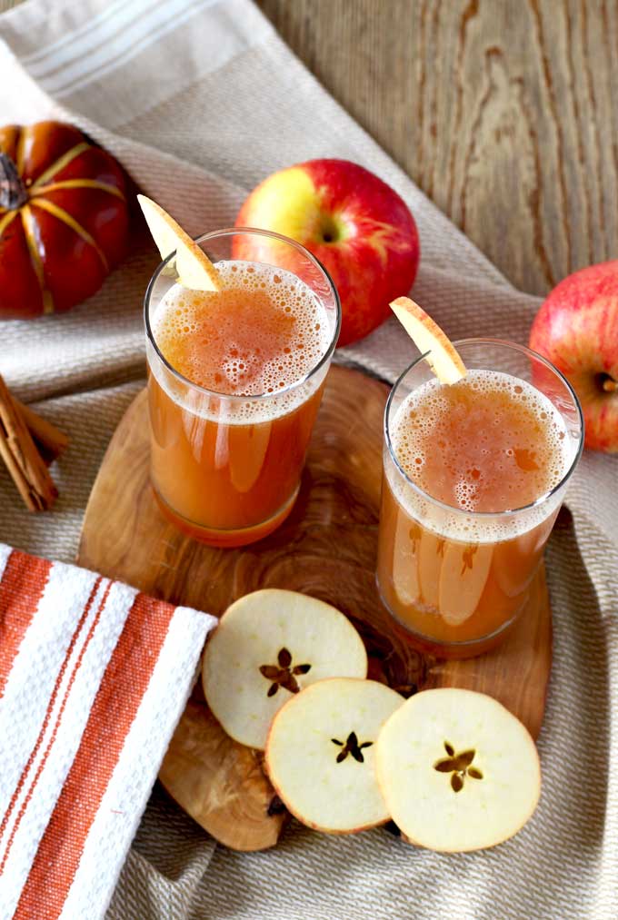 Harvest Shandy served in tall glasses and garnished with sliced apples.