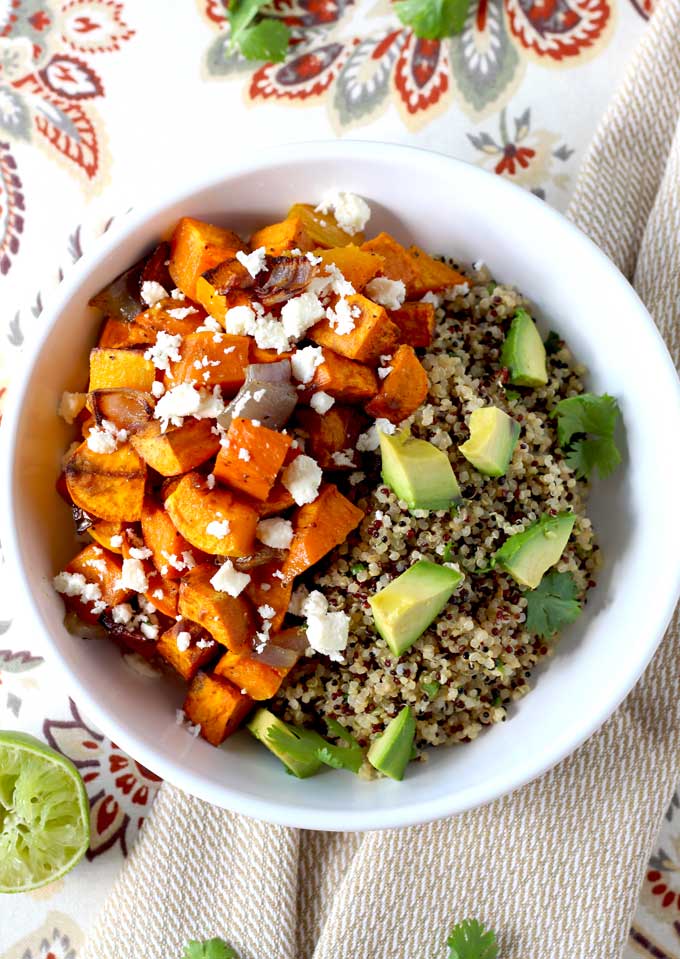 top view of Vegetarian Mexican Buddha bowl with butternut squash and sweet potatoes over wholesome cilantro lime quinoa topped with cotija cheese and avocado