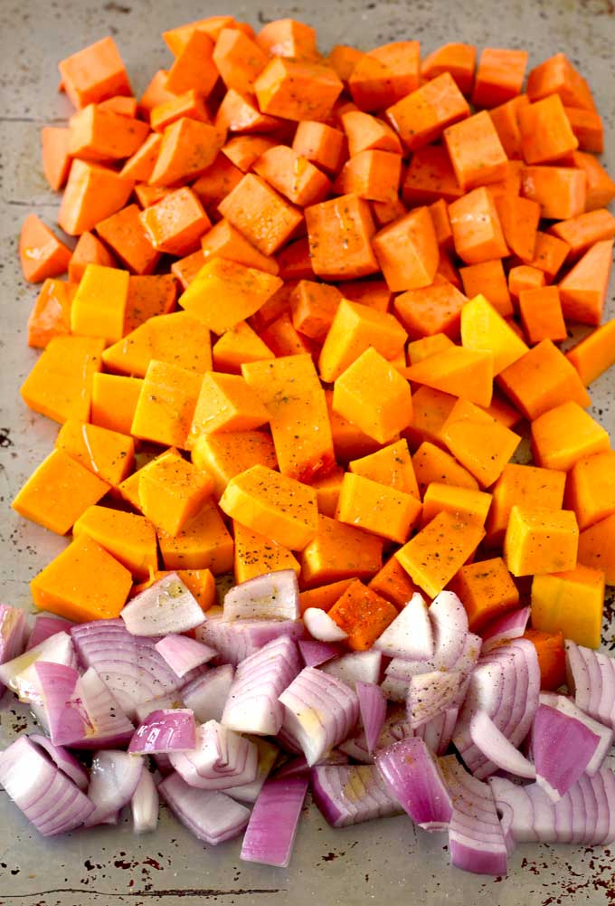 diced sweet potatoes, butternut squash and onion on a baking sheet