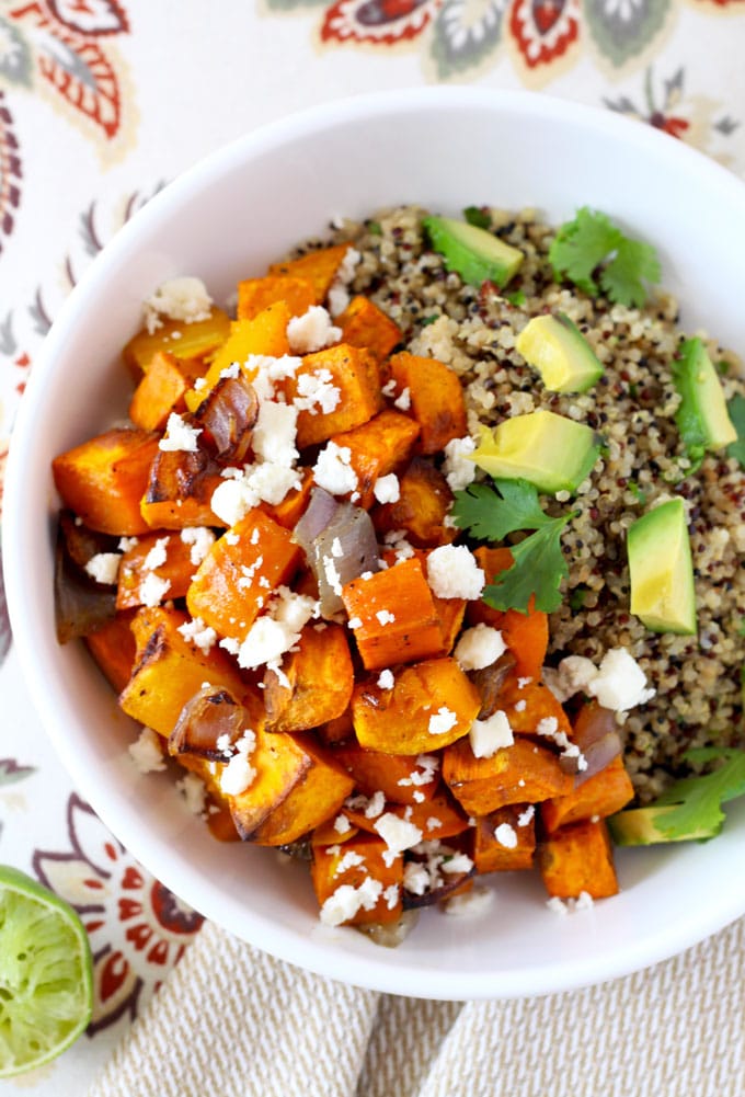 top view of a Vegetarian Mexican Buddha bowl with butternut squash and sweet potatoes over wholesome cilantro lime quinoa topped with cotija cheese and avocado
