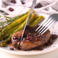 These Skillet Pork Chops are juicy, tender and easy to make. Boneless pork chops are seasoned with fresh rosemary, seared to perfection and topped with the tastiest Port wine and cranberry pan sauce.