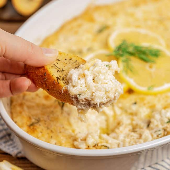Crostini topped with creamy and cheesy crab dip
