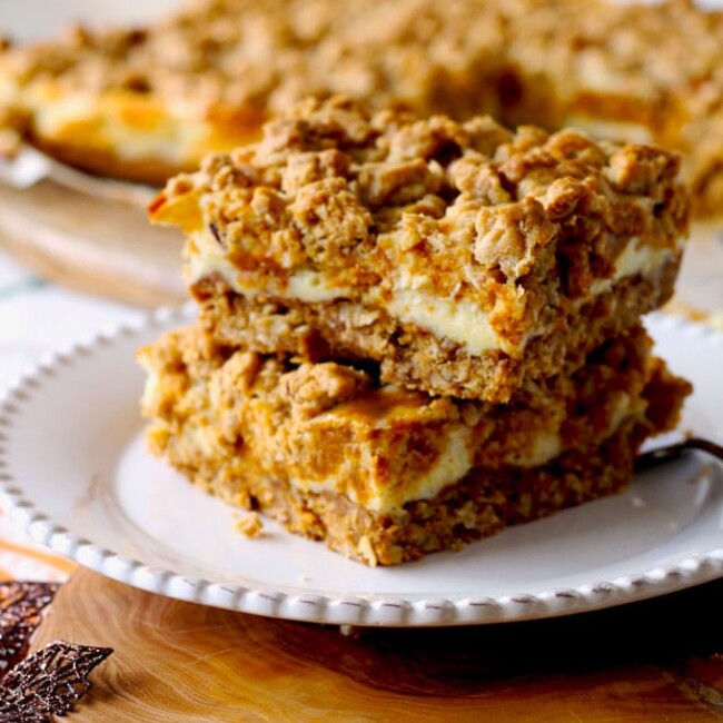 Soft and creamy these Pumpkin & Cheesecake Swirl Oat Bars are like a marriage between pumpkin cheesecake and an oatmeal cookie! Super delicious and easy to make.