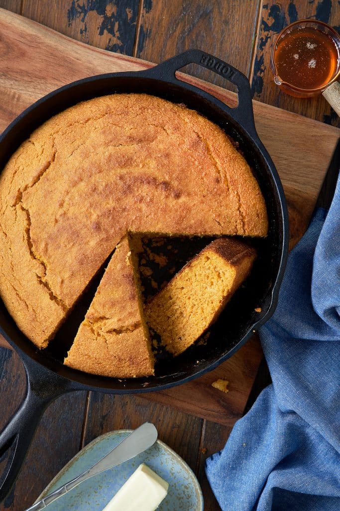 top view of a half sliced Sweet Potato Cornbread in a skillet