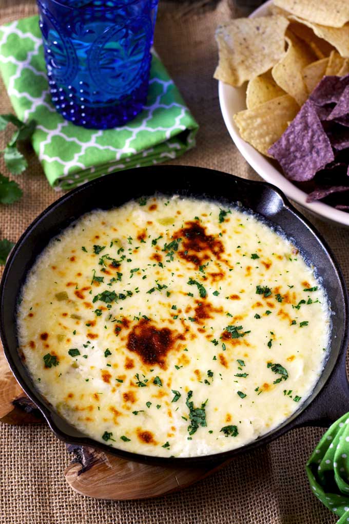 Queso Fundido dip served on a cast iron skillet.