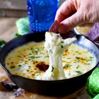This Queso Fundido dip is gooey, melty and delicious. Crumbled goat cheese takes this easy-to-make dip to the next level!