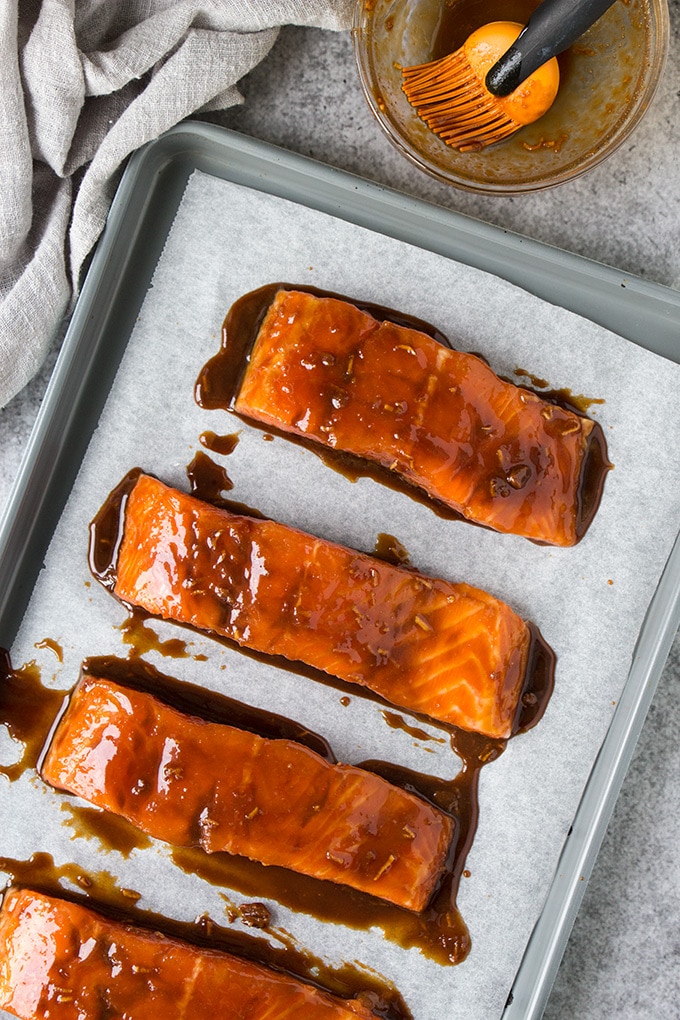 Salmon fillets on a sheet pan covered in miso glaze