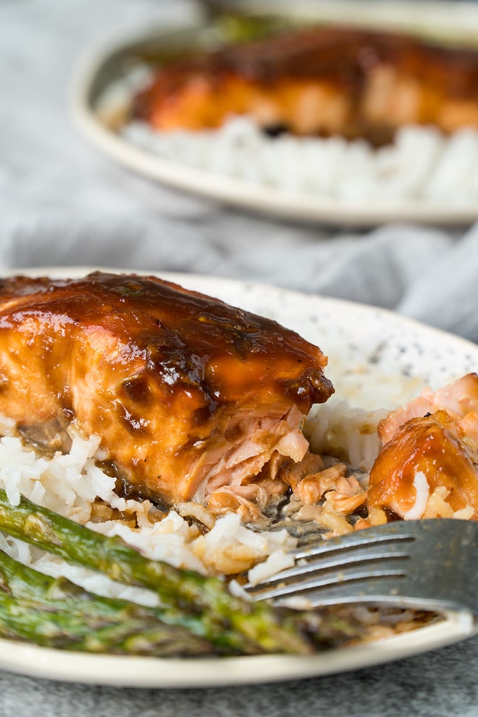 A fillet of miso salmon over rice with asparagus