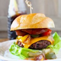 The Ultimate Cajun Burger is packed full of Cajun-Creole goodness! A moist Cajun spiced beef patty is topped with gooey cheddar cheese, sauteed onions, bell peppers and Andouille sausage. A true explosion of flavors!