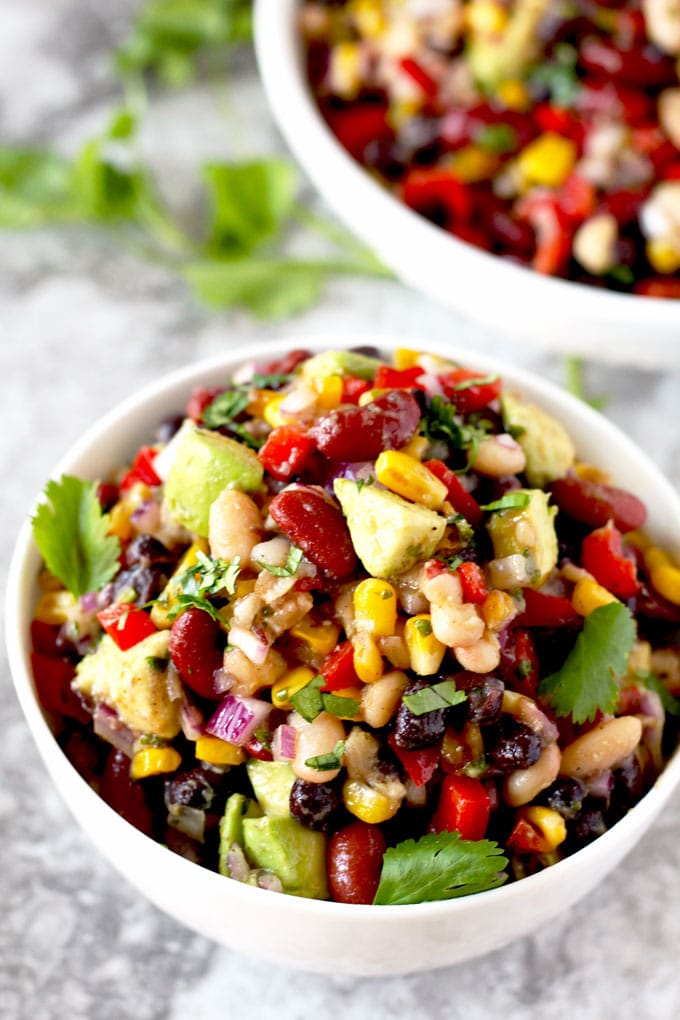 Close up top view of a serving of Mexican 3 Bean Salad garnished with cilantro leaves