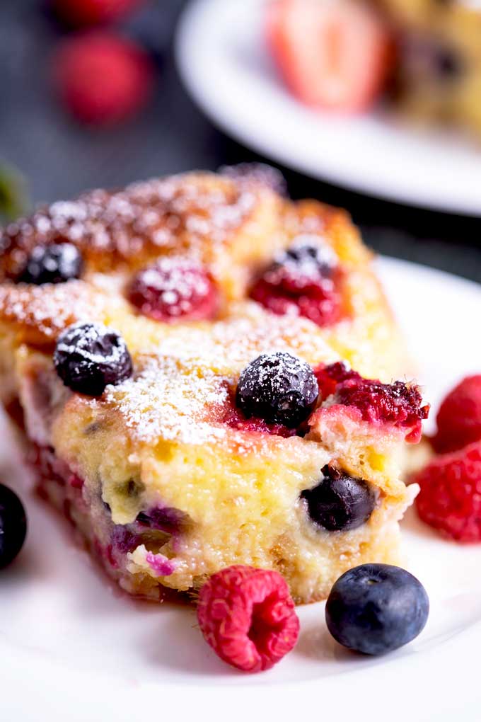Close up of a piece of mouthwatering tender and rich berry bread pudding.