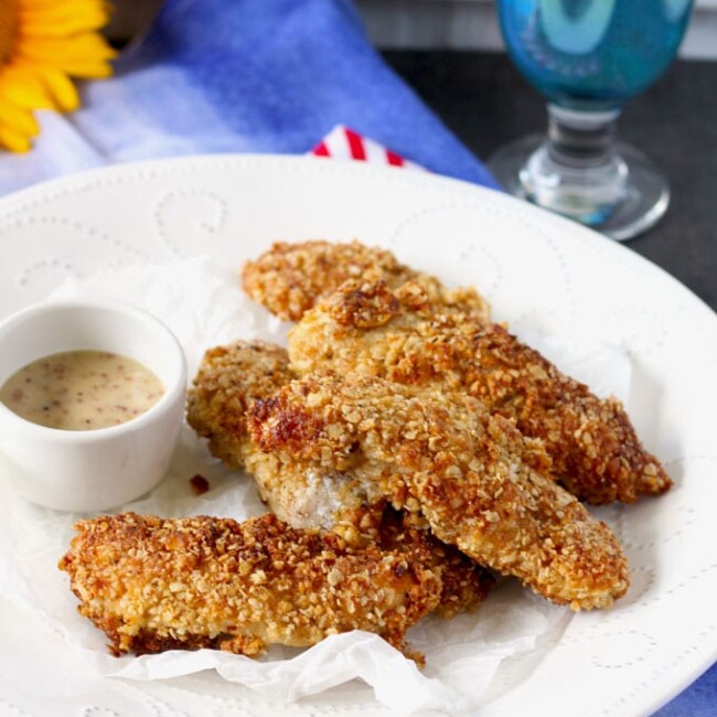 These Crunchy Macadamia Nut Crusted Chicken Tenders are coated in a delicious savory crust made from oats, macadamia nuts, Parmesan cheese and spices! So delicious it will become a family favorite!