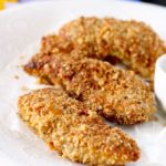 This Crunchy Macadamia Nut Crusted Chicken Tenders are coated in a delicious savory crust made from oats, macadamia nuts, Parmesan cheese and spices! So delicious it will become a family favorite!