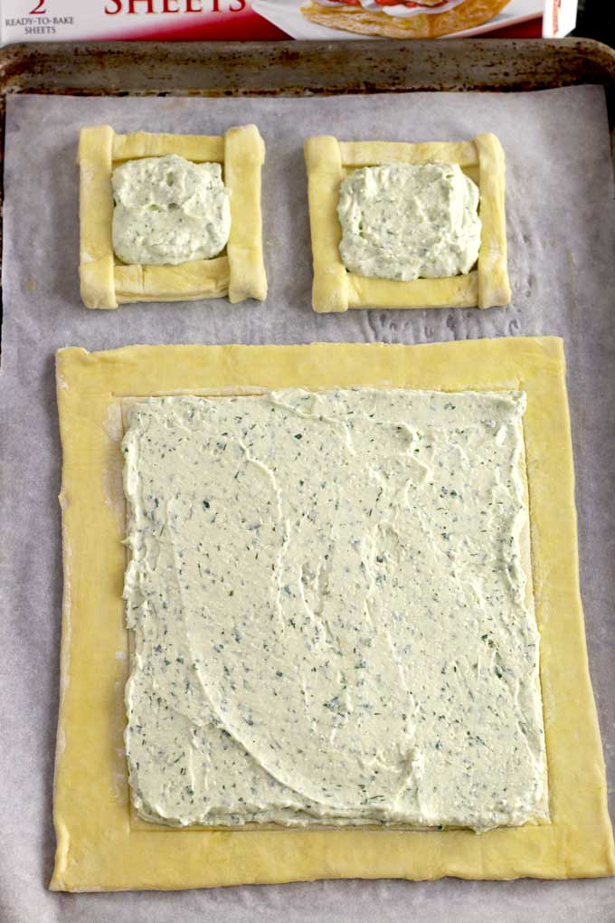 whipped cheese spread on the puff pastry sheets