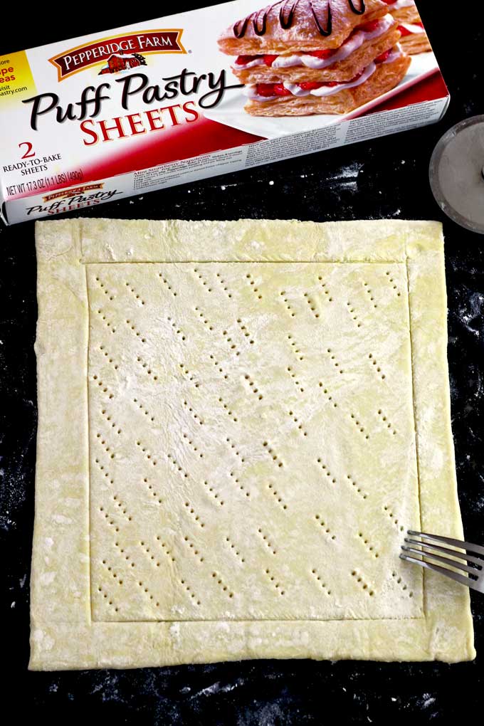 poking the puff pastry sheets with a fork
