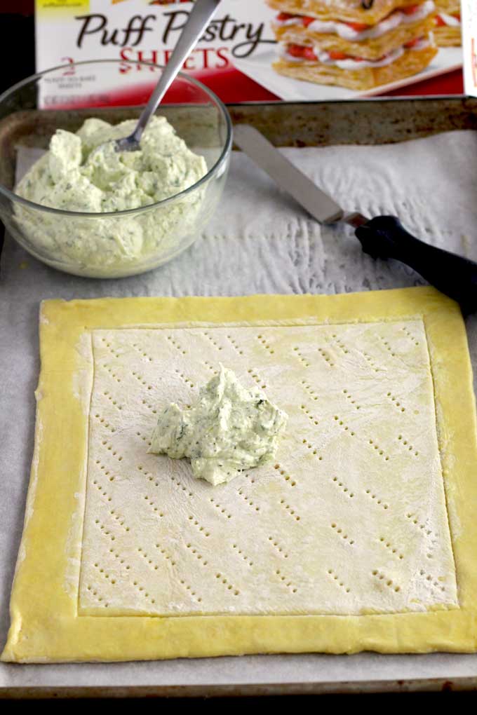 whipped feta on the center of the puff pastry sheets
