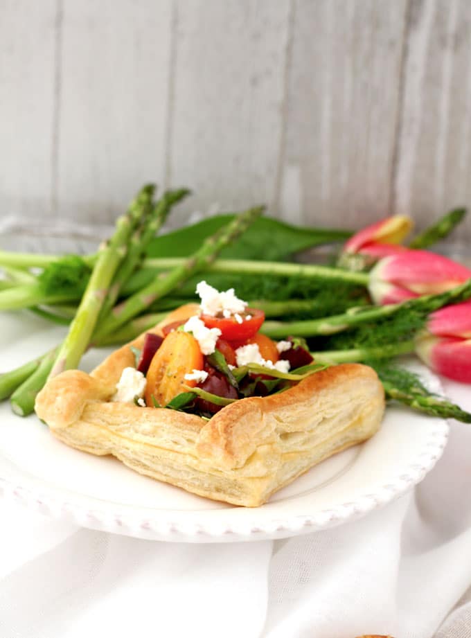 Small puff pastry tart on a white plate.