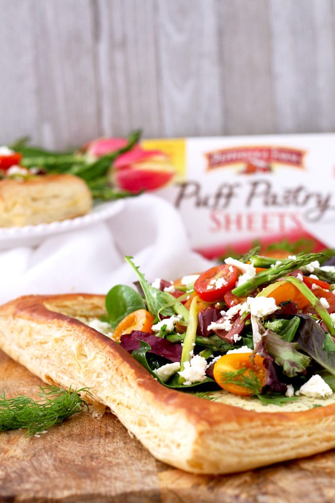 This perfectly golden brown and flaky Puff Pastry Tart with Tomatoes, Asparagus and Herbed Feta is delicious, easy to make and perfect served as an appetizer or lunch.
