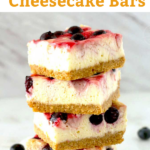 These Berry Swirl Cheesecake Bars are made with a delicious layer of rich and creamy cheesecake over a Graham cracker crust then topped with blueberries and the best raspberry swirl.