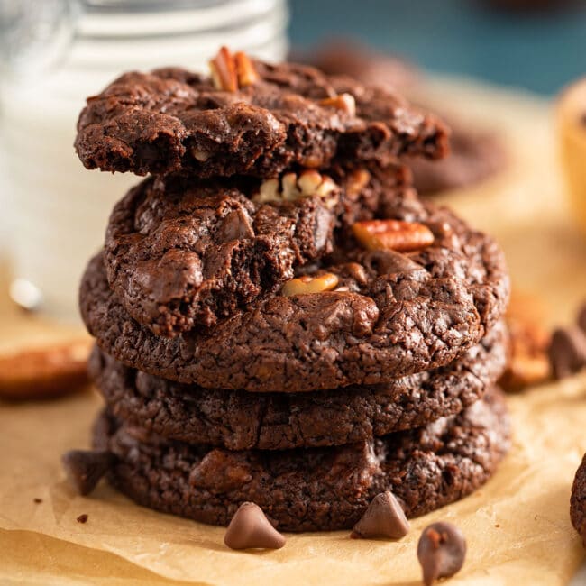 Stack of doble chocolate chip cookies with pecans.