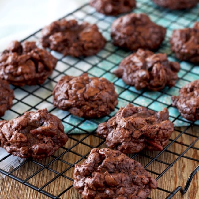 Gooey chocolate, chocolate chunks and crunchy pecans make these almost flour-less Fudgy and Nutty Double Chocolate Cookies pure decadence! Thick, rich and irresistible. These cookies are a chocolate lover’s dream!