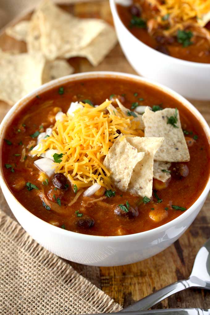 Chicken Enchilada Soup topped with sour cream, cheese and tortilla chips.