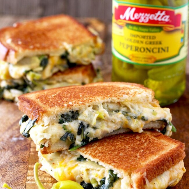 Buttery and toasty bread with an incredibly gooey and delicious filling. This easy Spinach and Artichoke Dip Cheese Melt is everything a grilled cheese sandwich should be and then some!! The addition of peperoncini adds brightness and zing to this delicious sandwich!