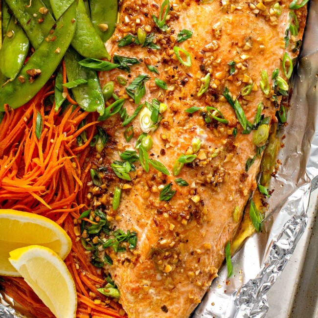 Succulent salmon fillet with shredded carrots and snow peas baked in foil