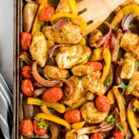 chicken, bell peppers and cherry tomatoes shawarma style on a sheet pan.