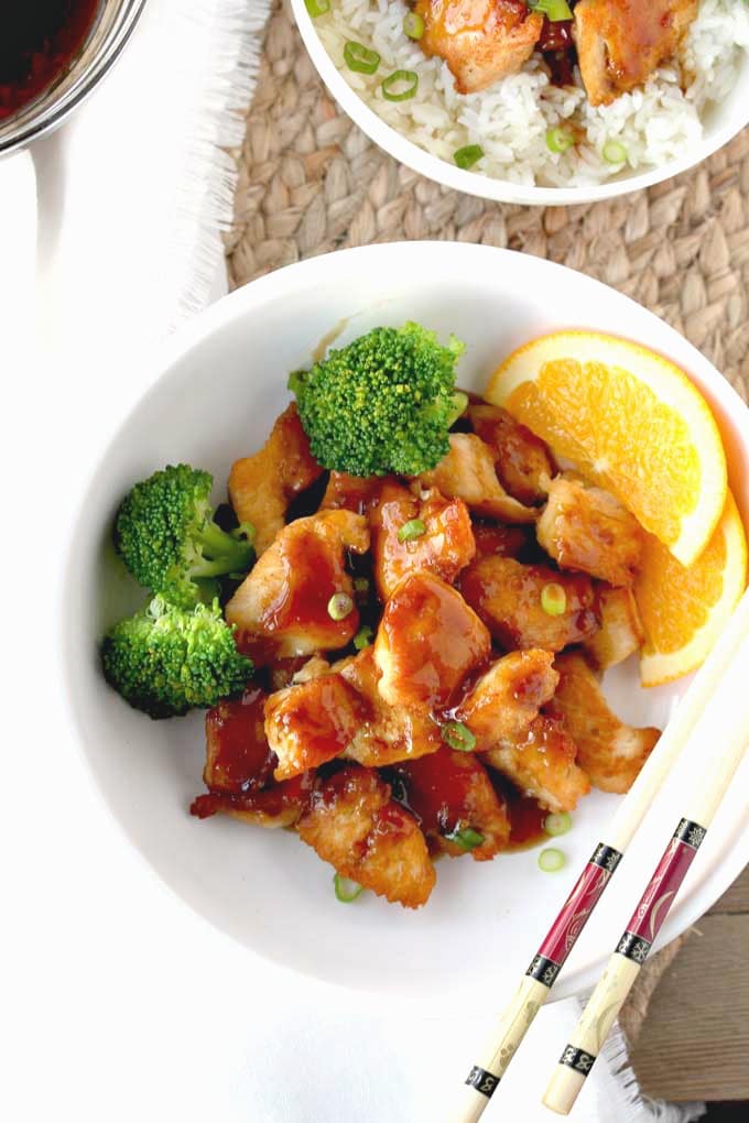 Top view of light and tasty Chinese chicken with orange sauce.