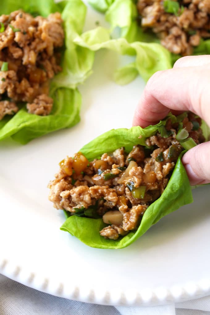 close-up shot of an Asian Chicken Lettuce wrap ready to be eaten