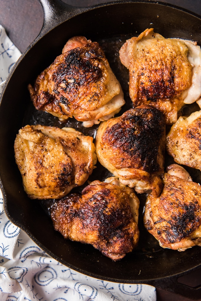 Crispy chicken thighs on a cast iron skillet