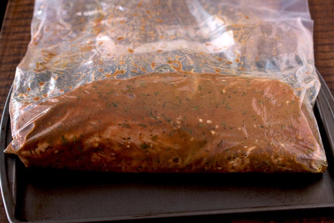 Pictured here a resealable bag with a pork loin and marinade inside