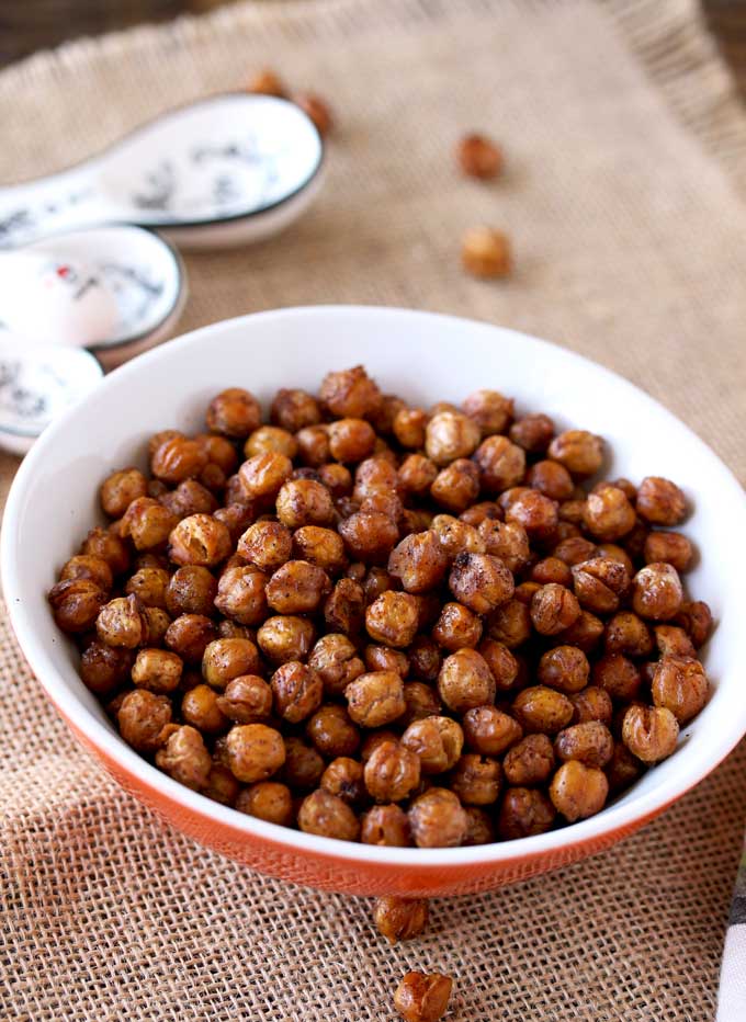 Pictured here is a small bowl filled with crispy seasoned oven roasted garbanzo beans.