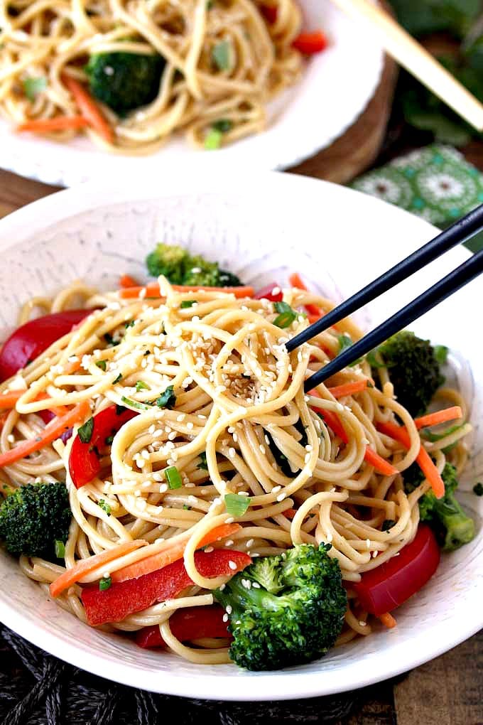 Asian noodles lifted with chopsticks.