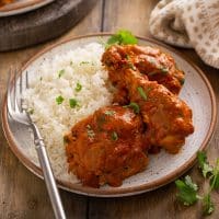 Chicken legs and thighs in a creamy Indian curry served with rice.