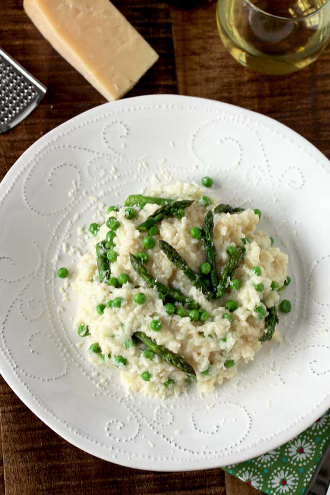 Top View of a plate with creamy Parmesan, Peas and Asparagus risotto