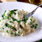 This Parmesan, Peas and Asparagus Risotto is creamy, rich, decadent and full of delicate flavors. This easy risotto recipe is made the way Chefs make it in restaurants. No constant stirring required, no guessing how much broth to add, yet it produces perfect creamy risotto every time! An elegant meal or side dish perfect for spring!