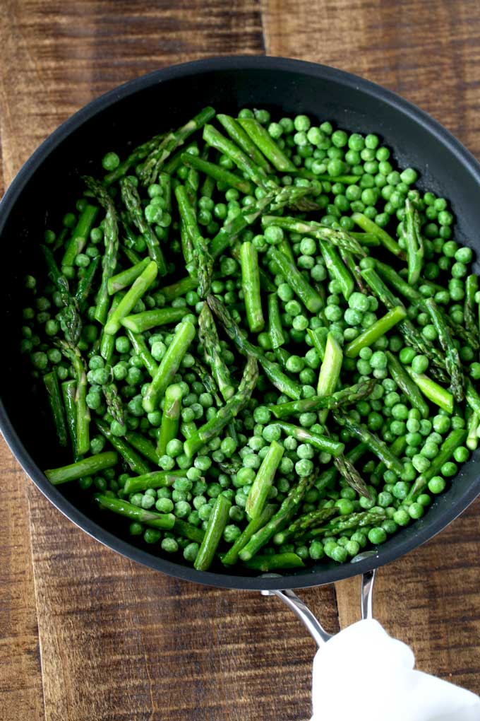 Asparagus and peas in a saute pan