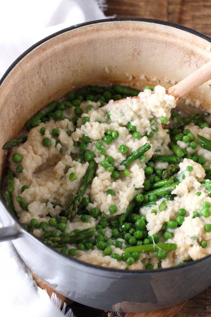 Risotto mixed with asparagus and peas in a Dutch oven