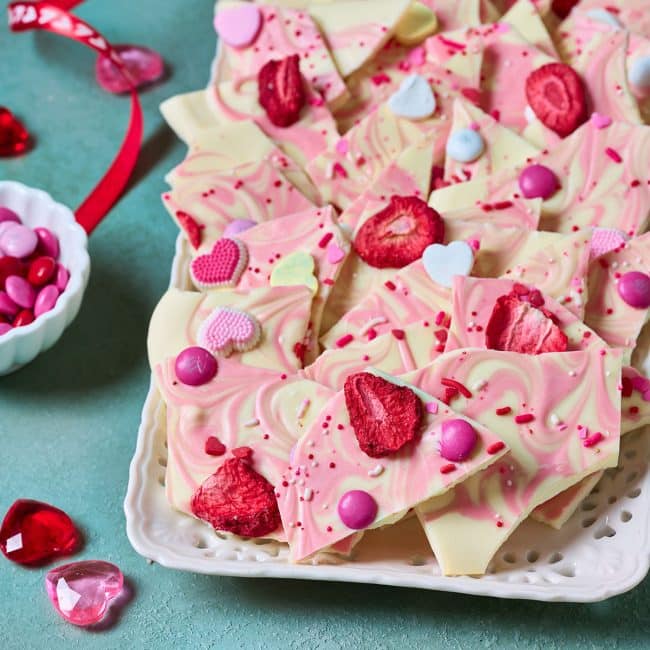 Valentine's Day White Chocolate Bark broken into pieces on a plate