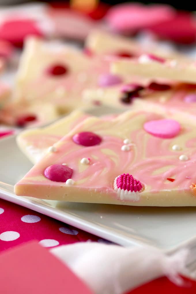 Close up view of a piece of marbled white chocolate bark with valentine's candy.