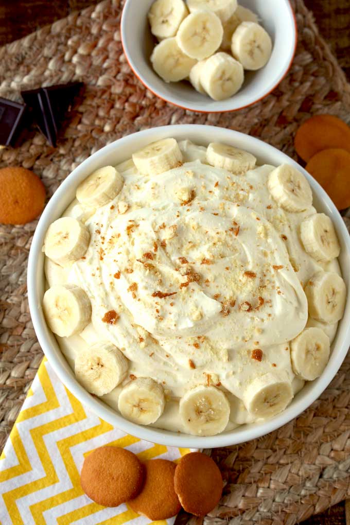 Top view of a white bowl filled with creamy banana cream pie dip