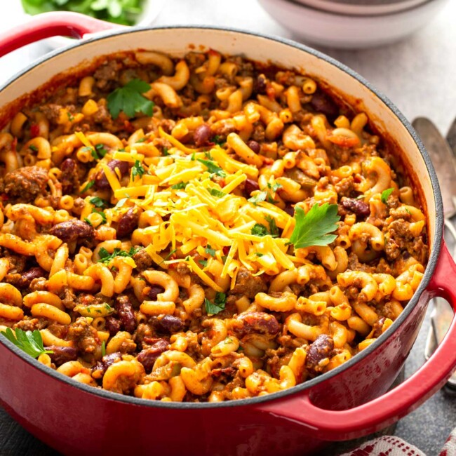 Chili macaroni and cheese or chili mac in a red Dutch oven pot